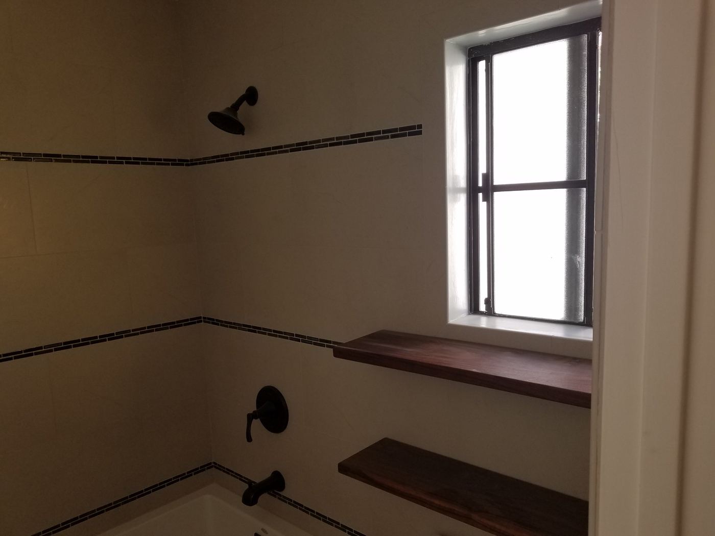 Walnut shelves under the window