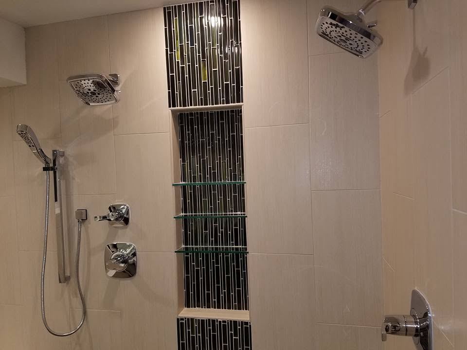 Dual shower heads and a full-height mosaic niche