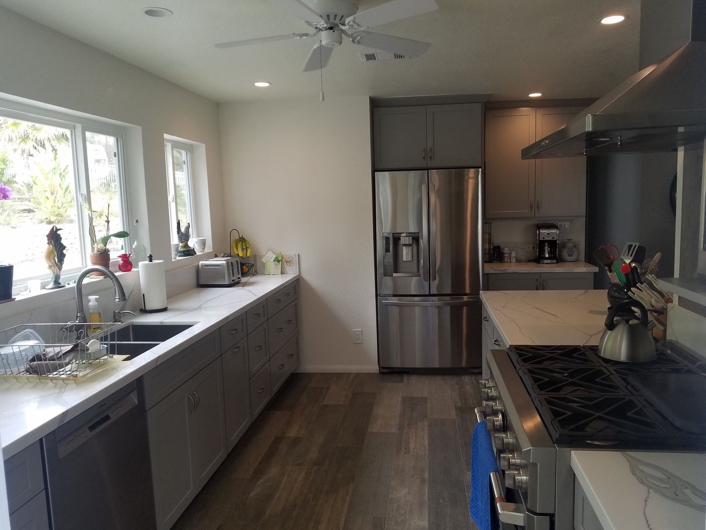 Gray shaker cabinets, quartz counters and wood-look tile floor
